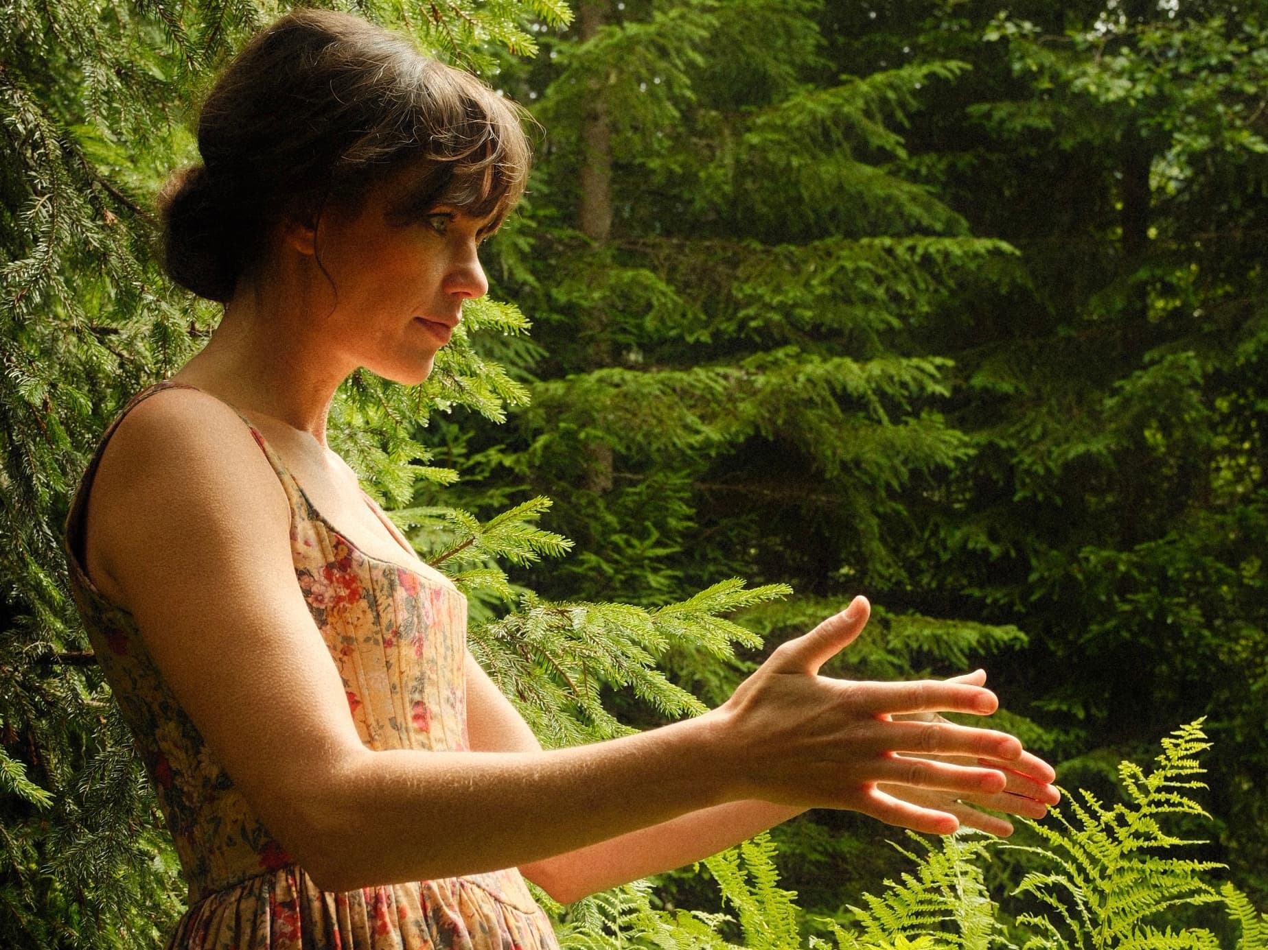Women in a forest, pointing her palms to the sky